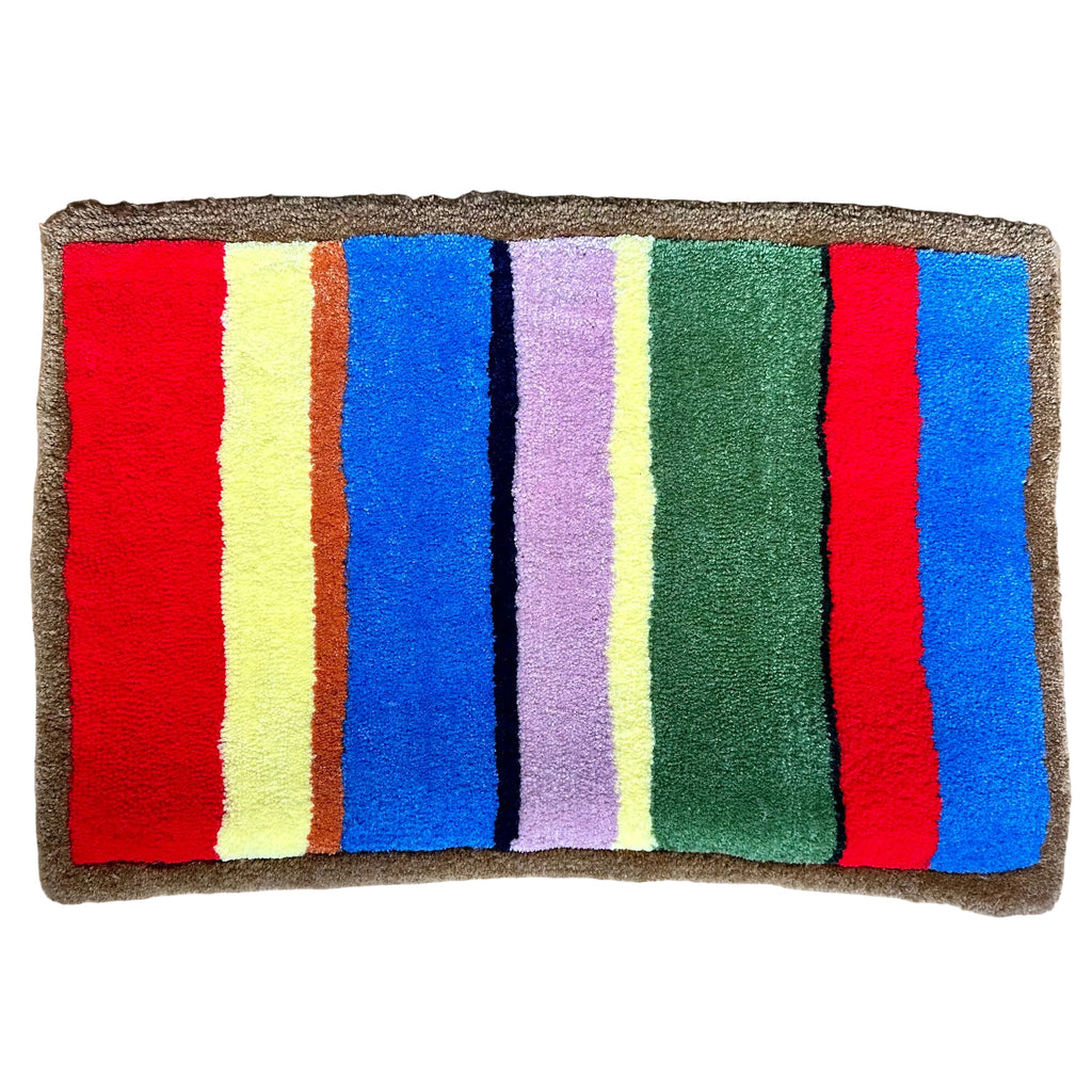Colorful striped hand tufted rug with red, yellow, blue, pink, orange, and green stripes