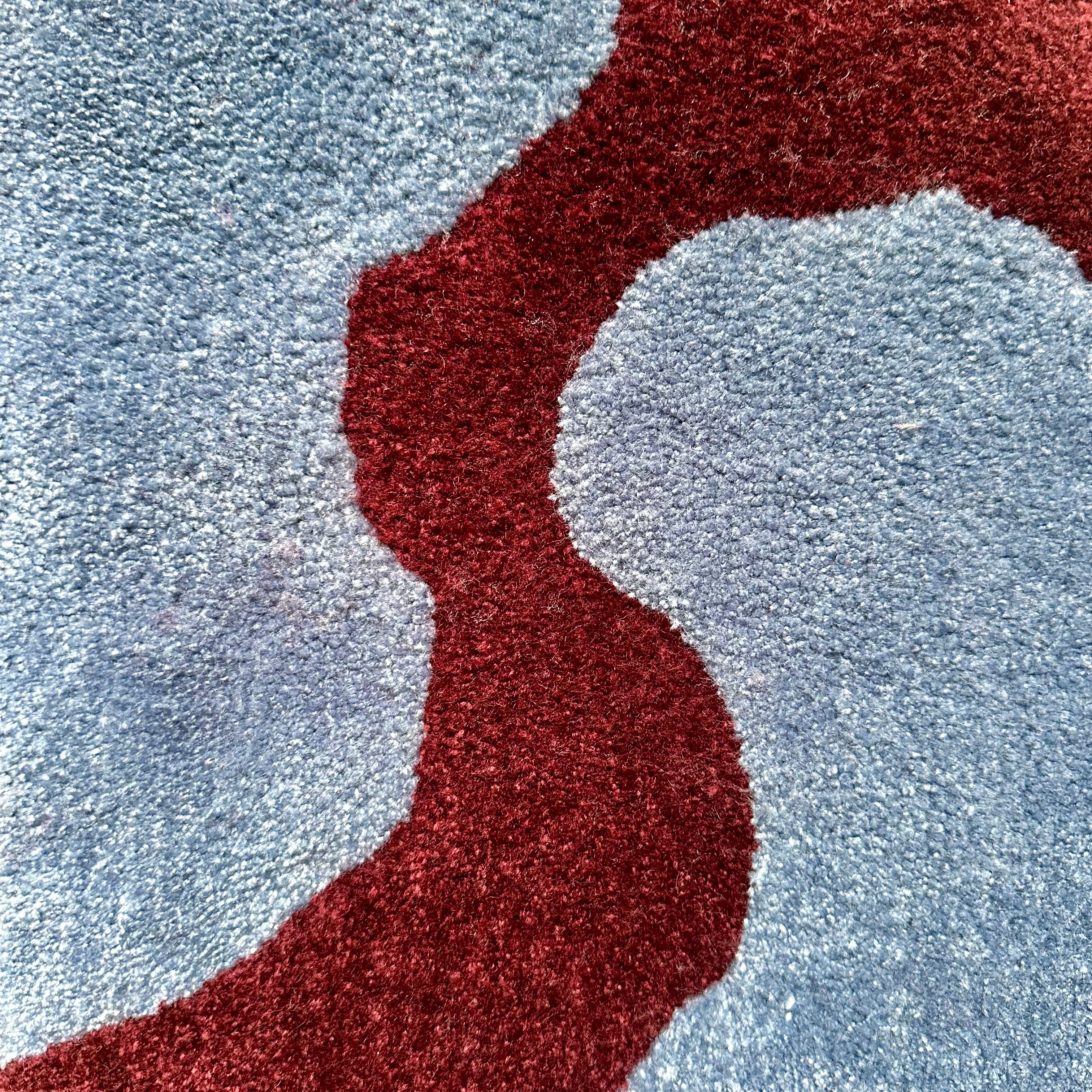 Close-up of a burgundy textured line on a light blue background